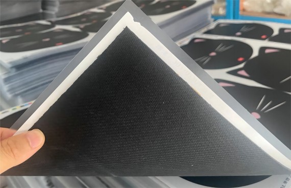 A hard PVC layer is glued onto the natural rubber base